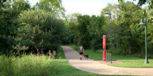 Man walking dog on Hudson Park Trail in Bryan, TX